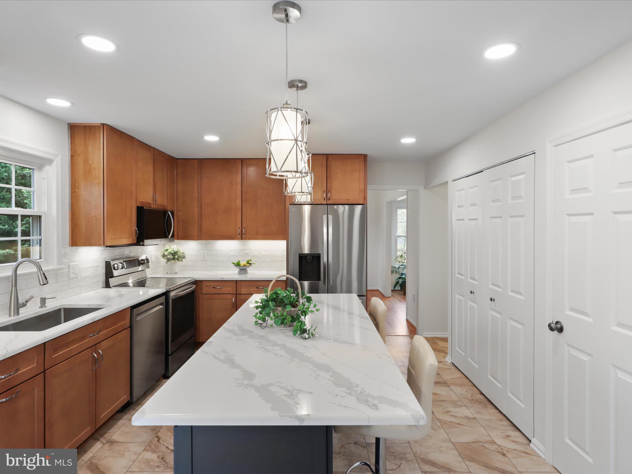 332 Silver Ridge Drive Sterling, VA 20164 - Photo 15 of 53 a large kitchen with kitchen island a sink stainless steel appliances and cabinets