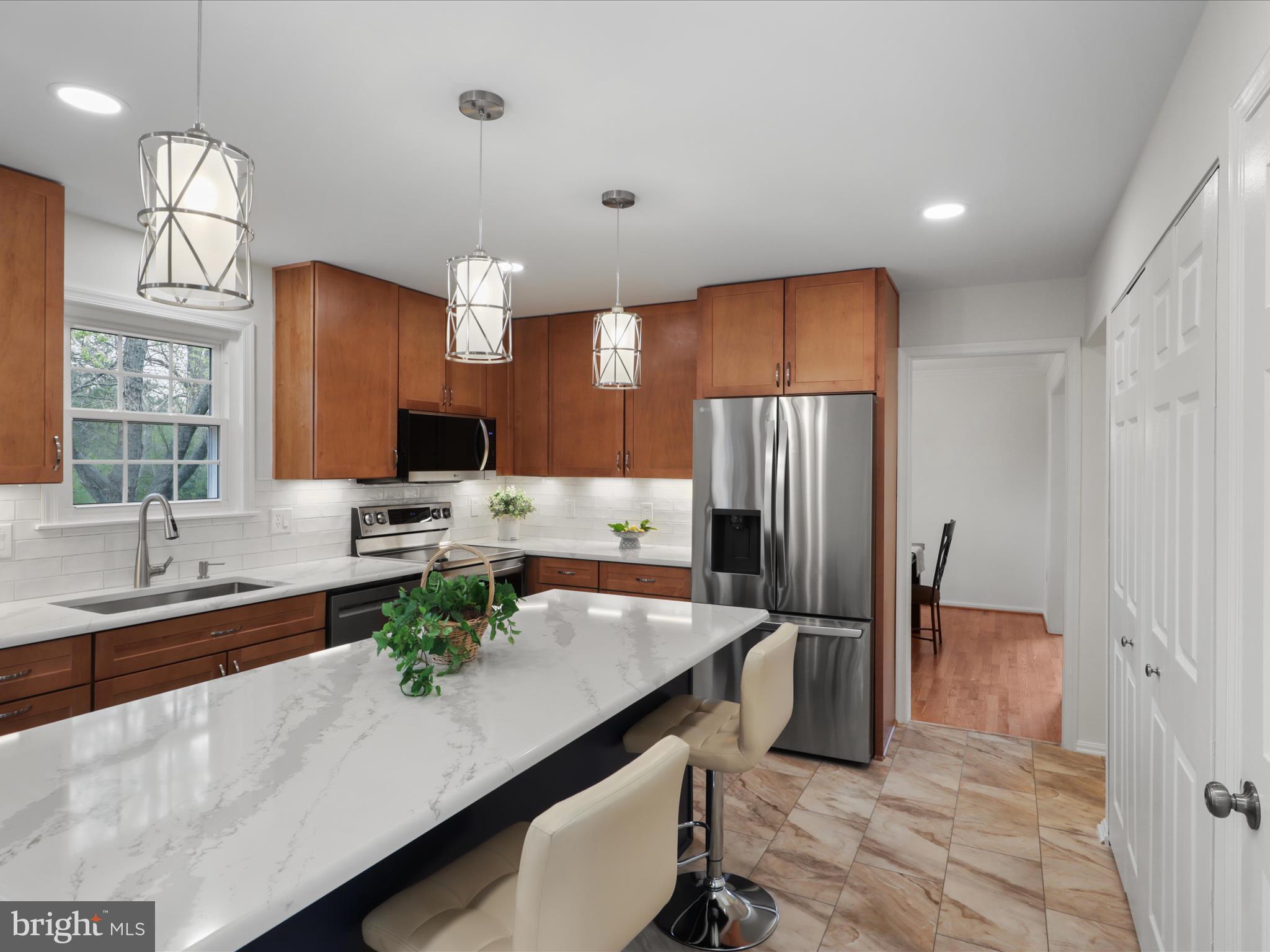 332 Silver Ridge Drive Sterling, VA 20164 - Photo 16 of 53 a kitchen with refrigerator and cabinets