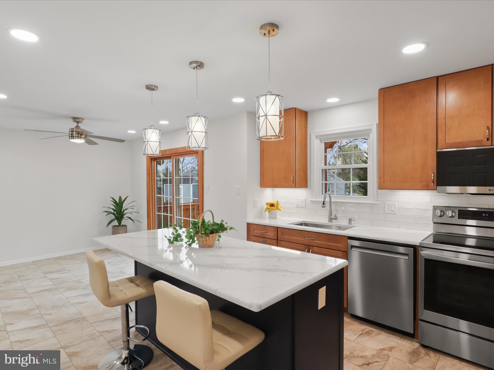 332 Silver Ridge Drive Sterling, VA 20164 - Photo 17 of 53 a kitchen with stainless steel appliances granite countertop a sink a stove and a refrigerator