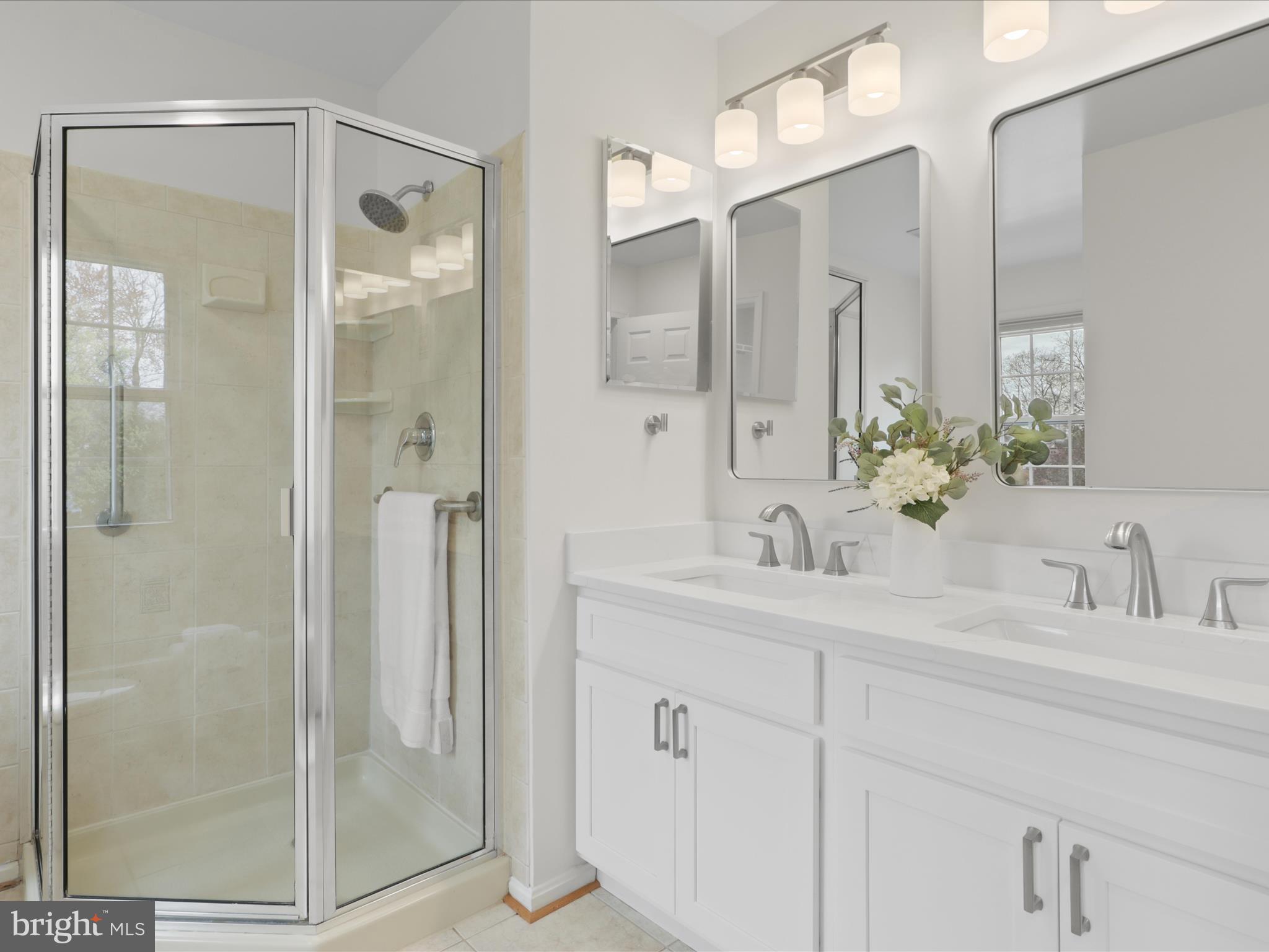 332 Silver Ridge Drive Sterling, VA 20164 - Photo 37 of 53 a bathroom with a shower sink and mirror
