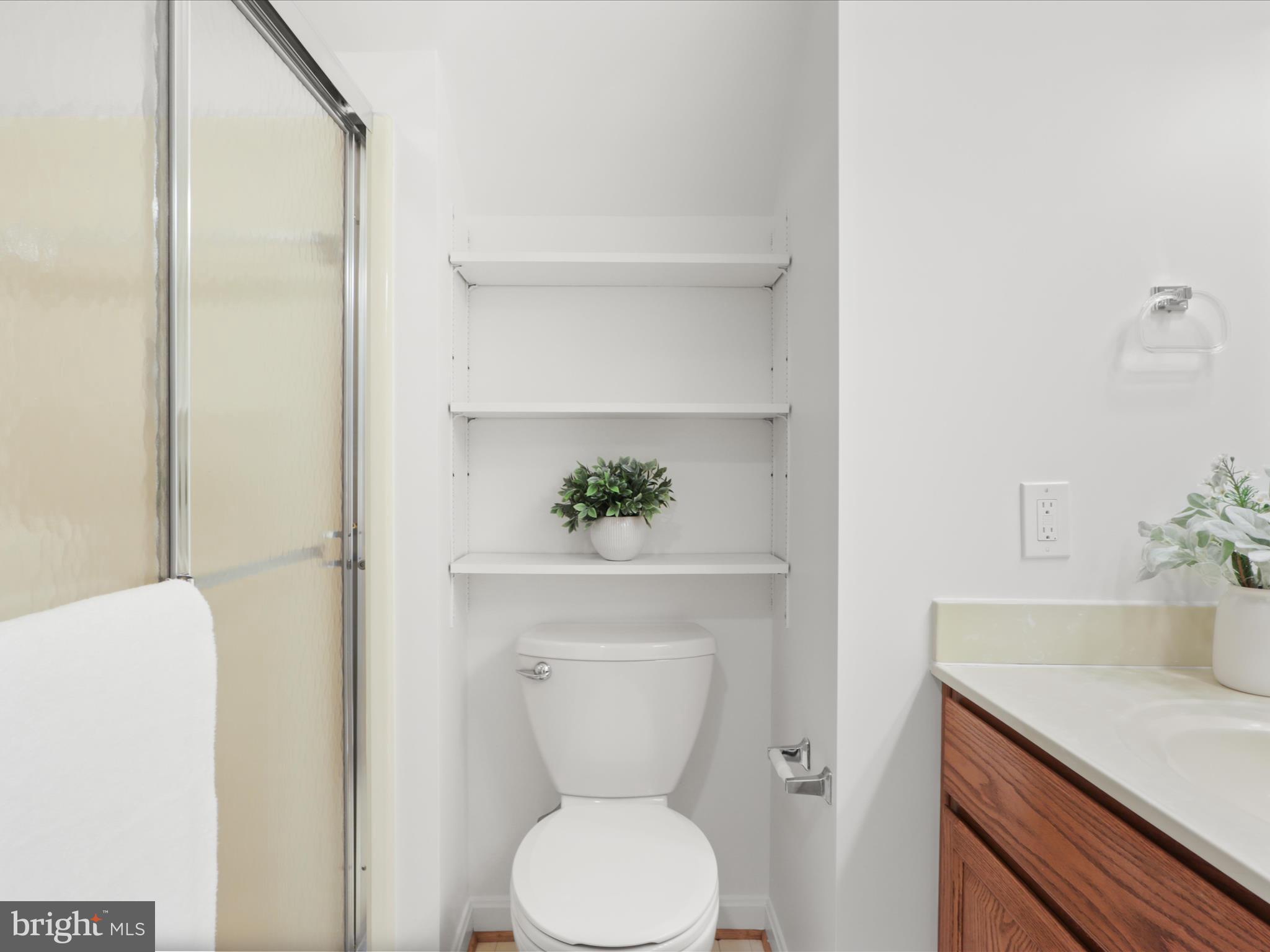 332 Silver Ridge Drive Sterling, VA 20164 - Photo 43 of 53 a bathroom with a toilet a sink and a mirror