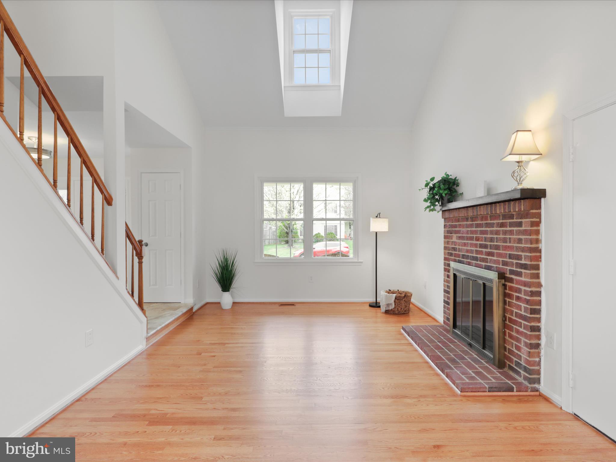 332 Silver Ridge Drive Sterling, VA 20164 - Photo 8 of 53 a view of empty room with wooden floor and fireplace