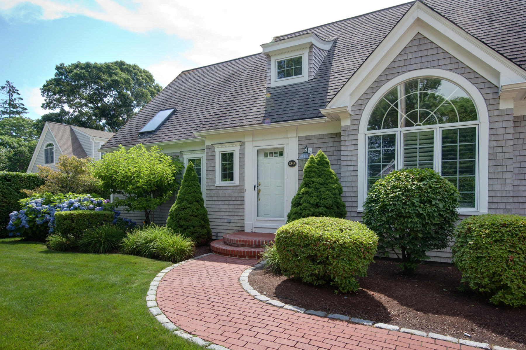 139 West Bay Road Osterville, MA 02655 - Photo 1 of 18 a view of a brick house with plants and large trees