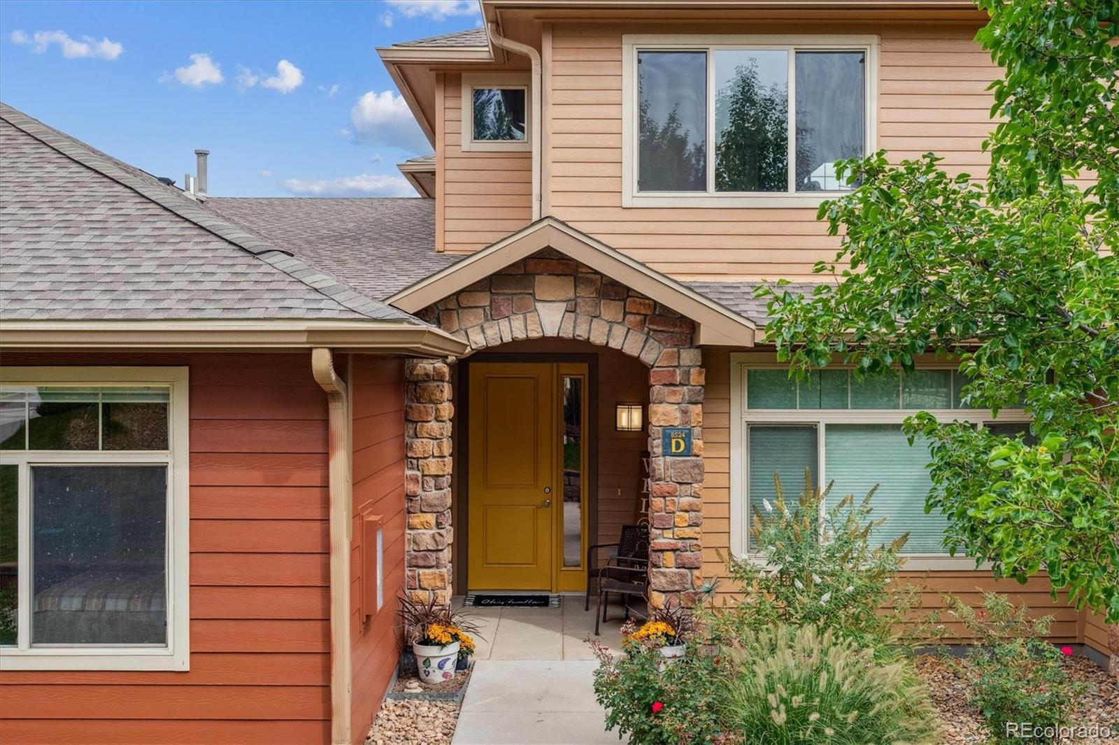 a front view of a house with garden