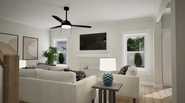 a living room with furniture a flat screen tv and a window