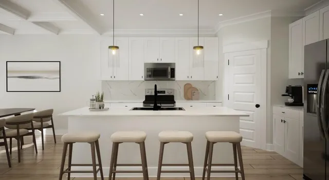 a kitchen with stainless steel appliances kitchen island granite countertop a dining table and chairs