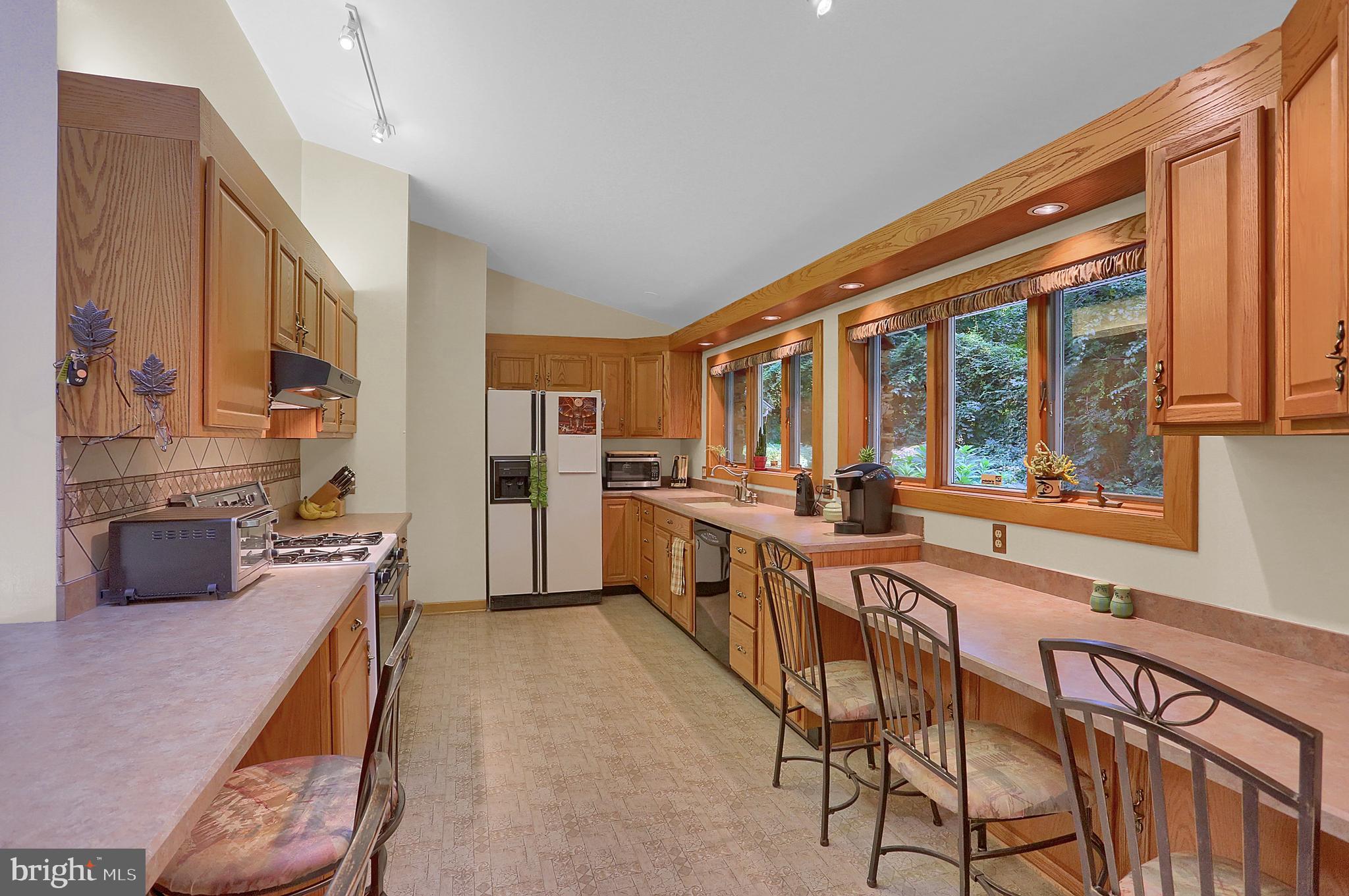 3336 Offutt Road Randallstown, MD 21133 - Photo 12 of 45 a large kitchen with a large window and stainless steel appliances