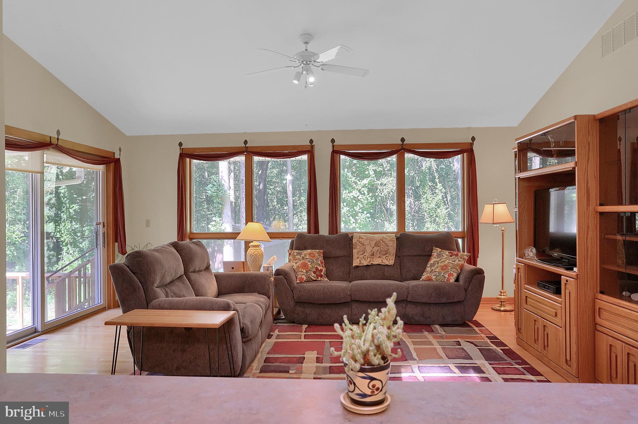 3336 Offutt Road Randallstown, MD 21133 - Photo 15 of 45 a living room with furniture two large window and wooden floor