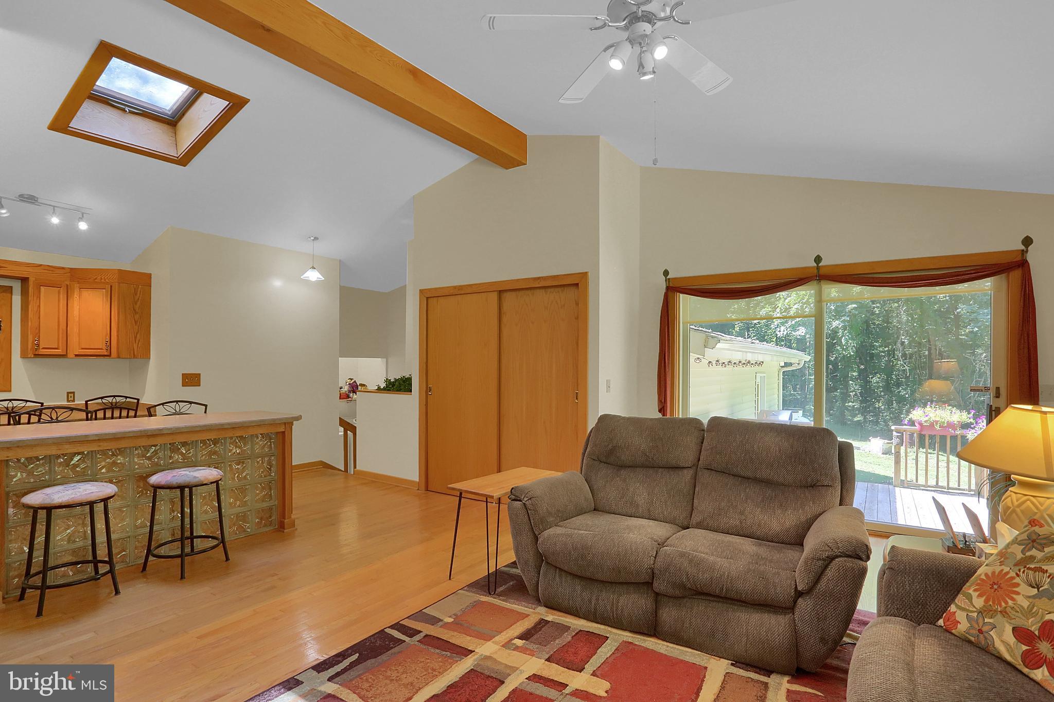 3336 Offutt Road Randallstown, MD 21133 - Photo 18 of 45 a living room with furniture a large window and a flat screen tv