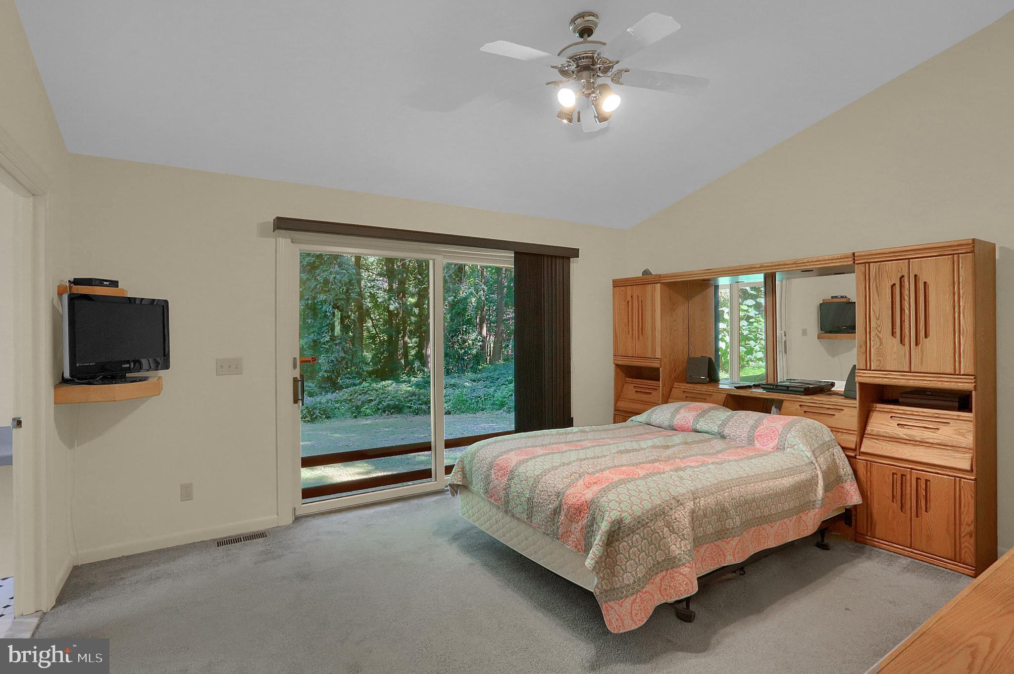 3336 Offutt Road Randallstown, MD 21133 - Photo 21 of 45 a bedroom with a large bed tv and a window