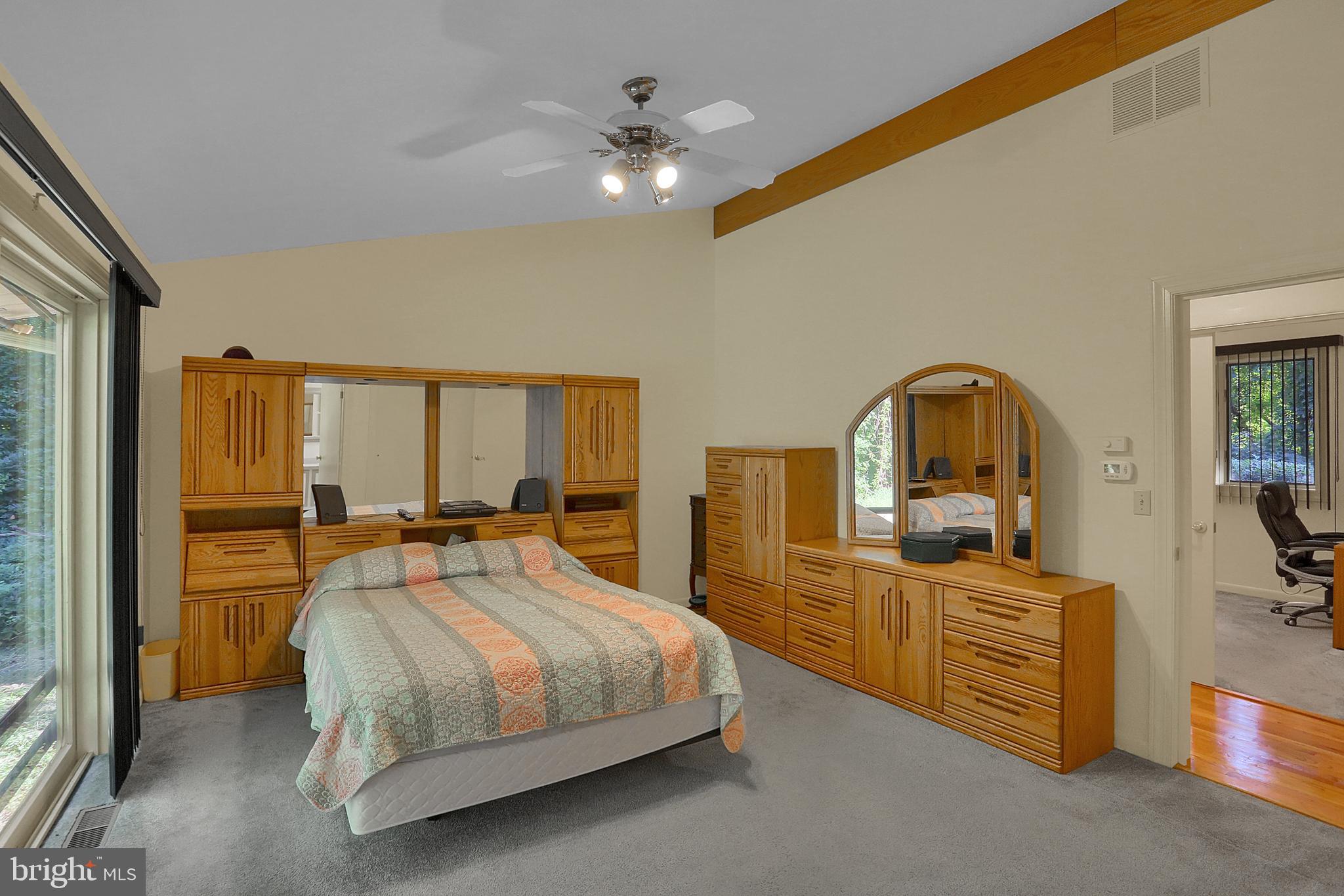 3336 Offutt Road Randallstown, MD 21133 - Photo 23 of 45 a bedroom with a bed and a dresser with mirror