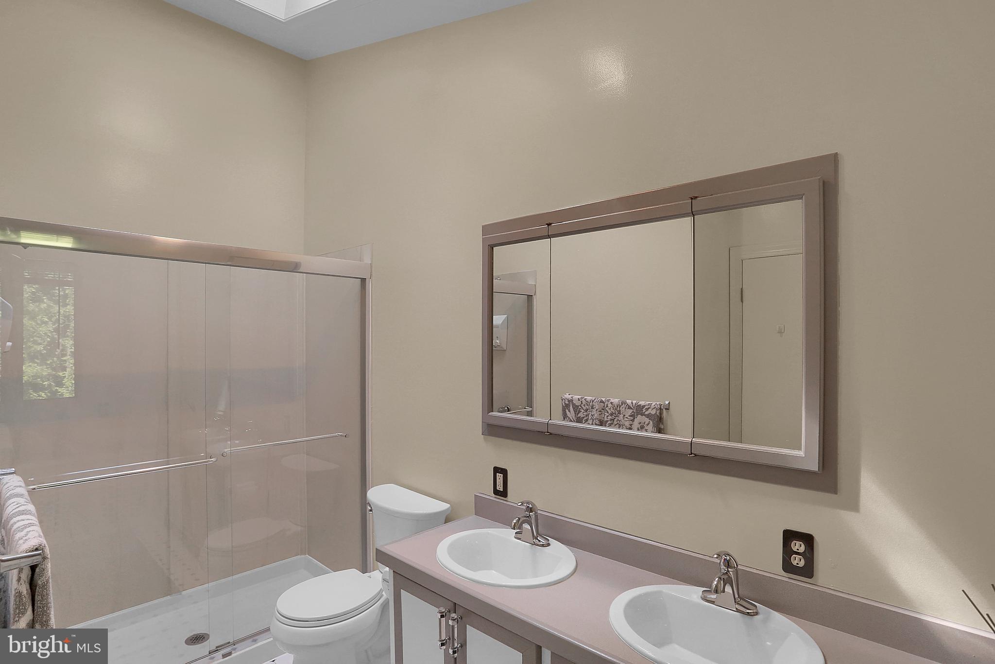 3336 Offutt Road Randallstown, MD 21133 - Photo 24 of 45 a bathroom with a sink toilet a mirror and shower