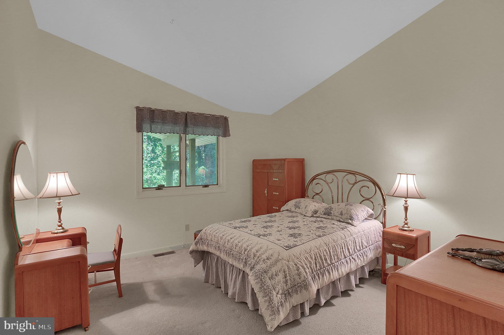 3336 Offutt Road Randallstown, MD 21133 - Photo 26 of 45 a bedroom with a bed and a lamp on dresser