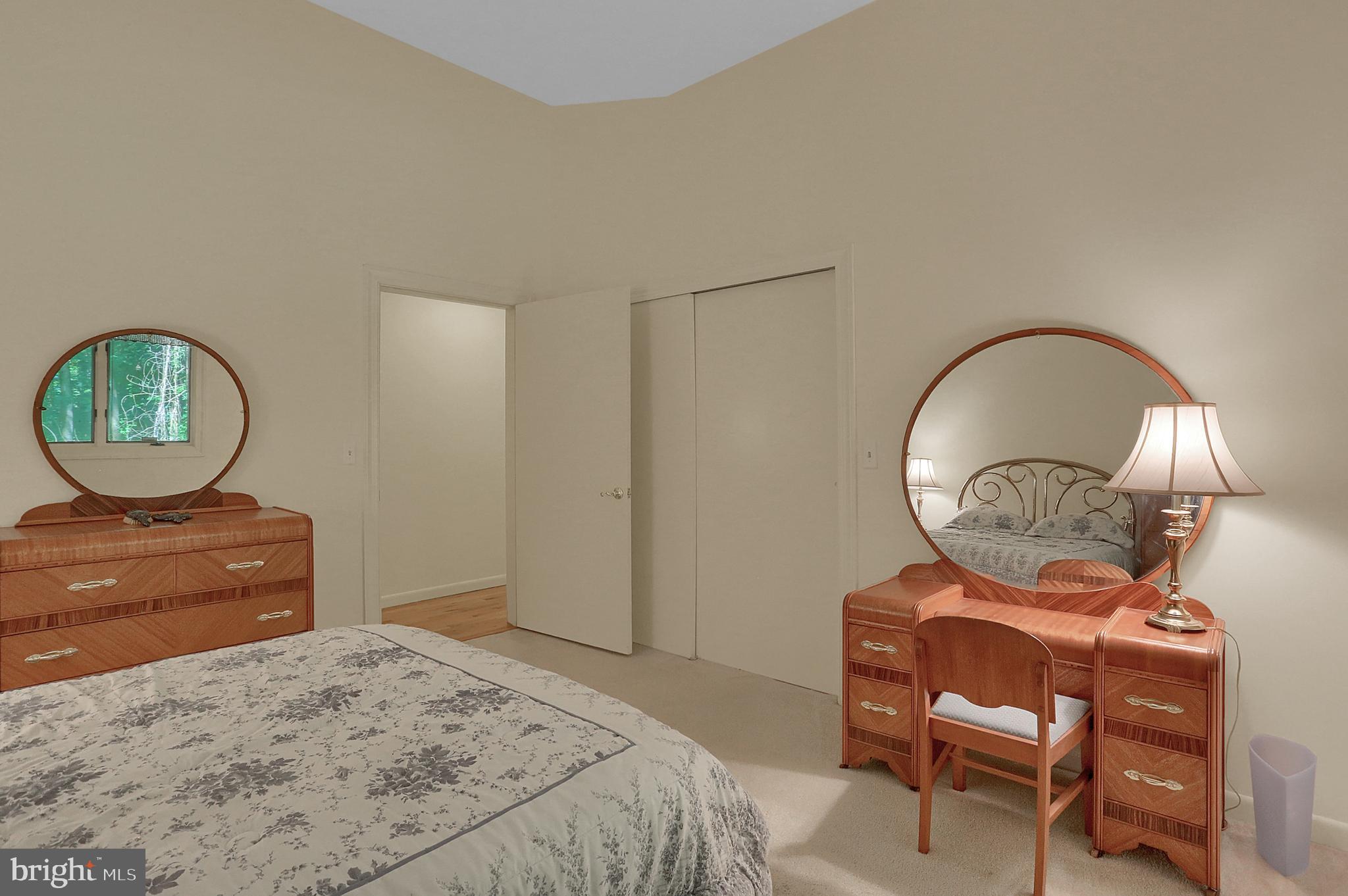 3336 Offutt Road Randallstown, MD 21133 - Photo 27 of 45 a bedroom with a bed a mirror and lamp