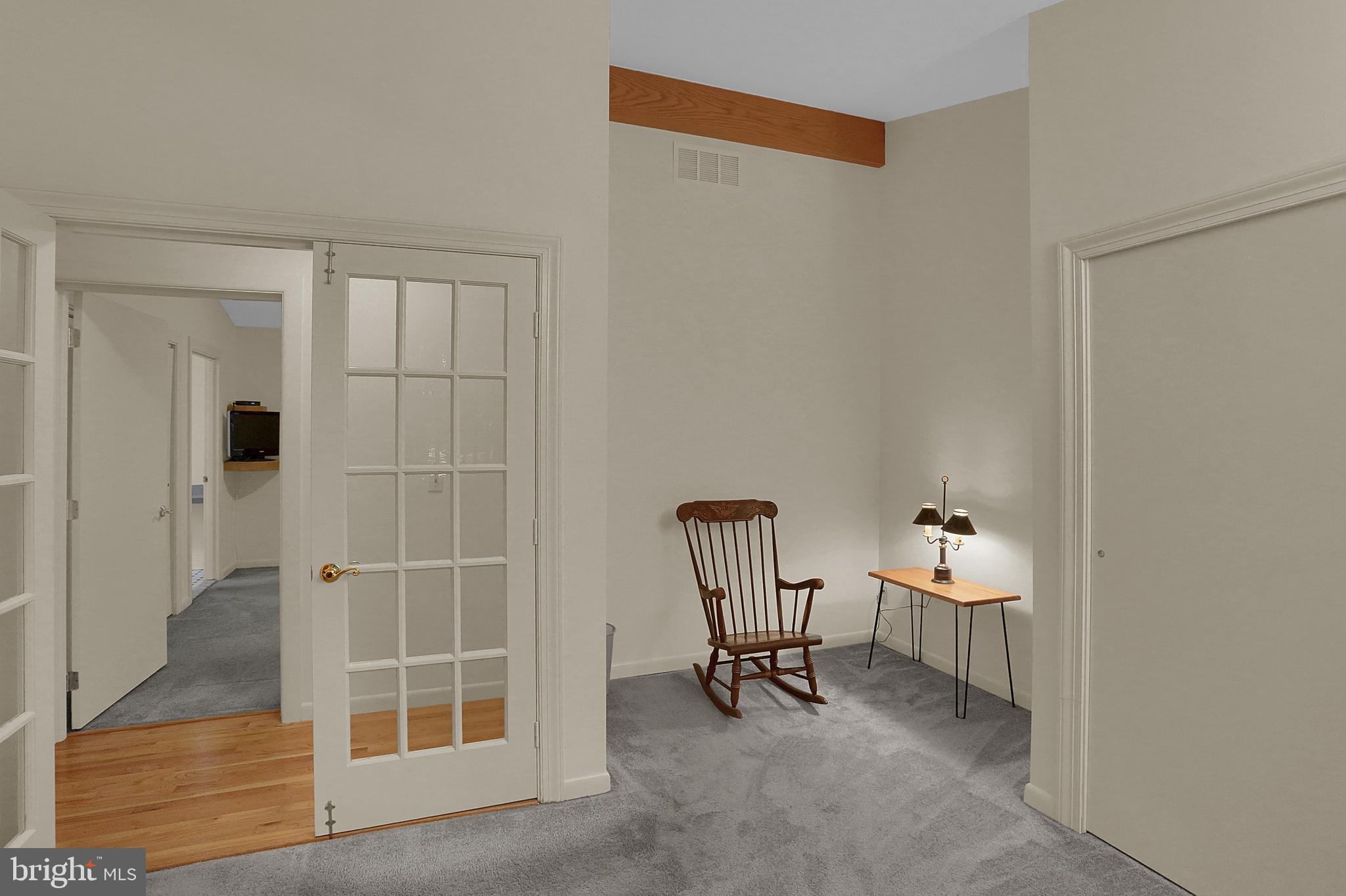3336 Offutt Road Randallstown, MD 21133 - Photo 28 of 45 an empty room with windows and chair