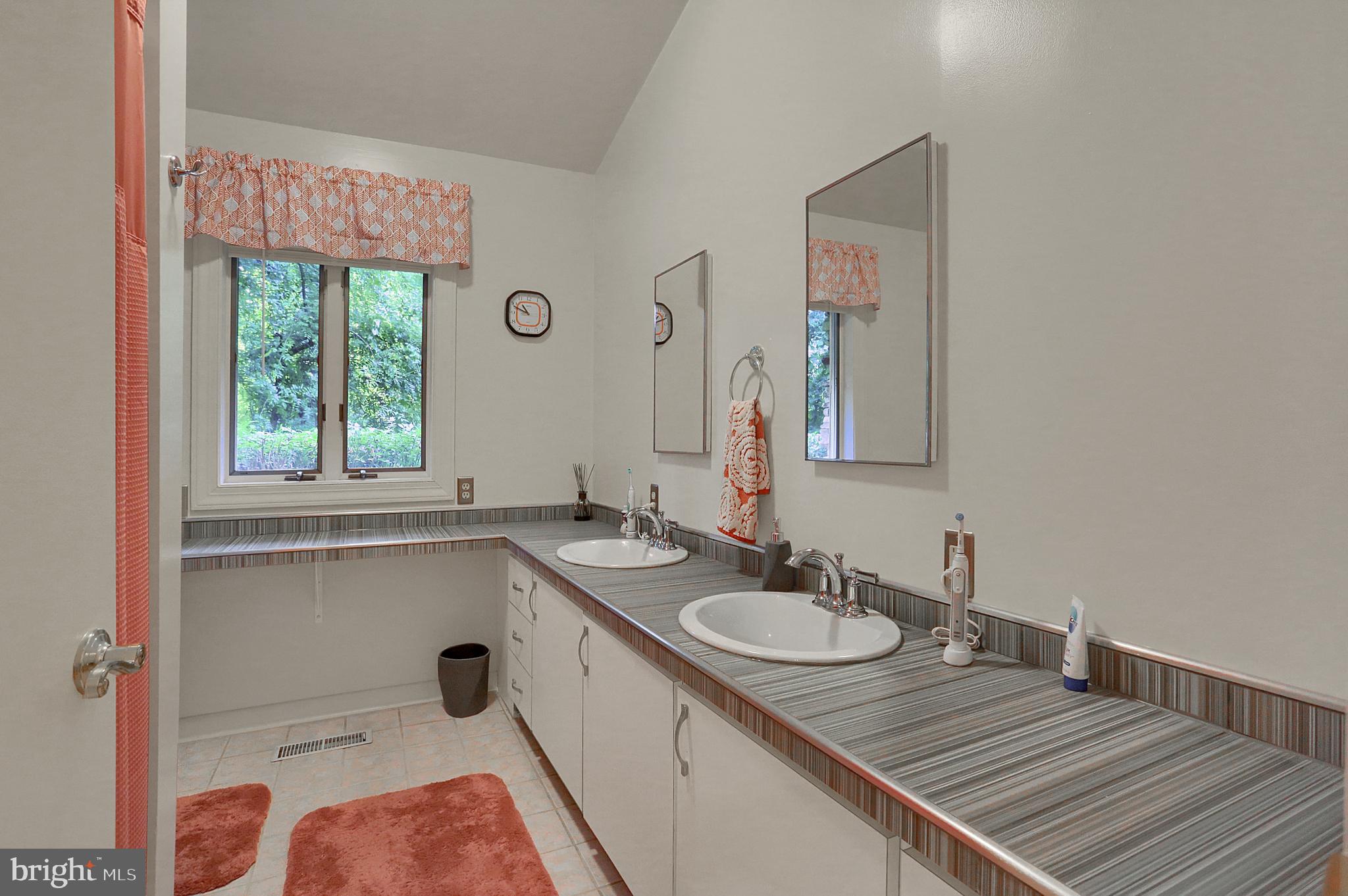 3336 Offutt Road Randallstown, MD 21133 - Photo 32 of 45 a bathroom with a sink and a mirror