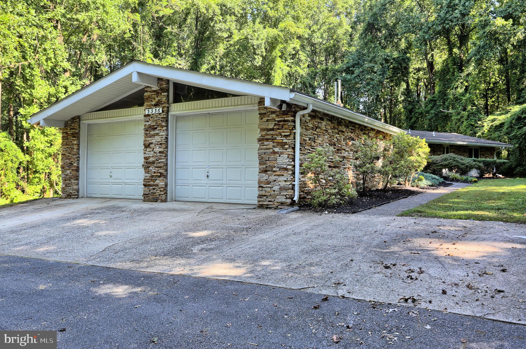 3336 Offutt Road Randallstown, MD 21133 - Photo 38 of 45 a front view of a house with a yard and garage