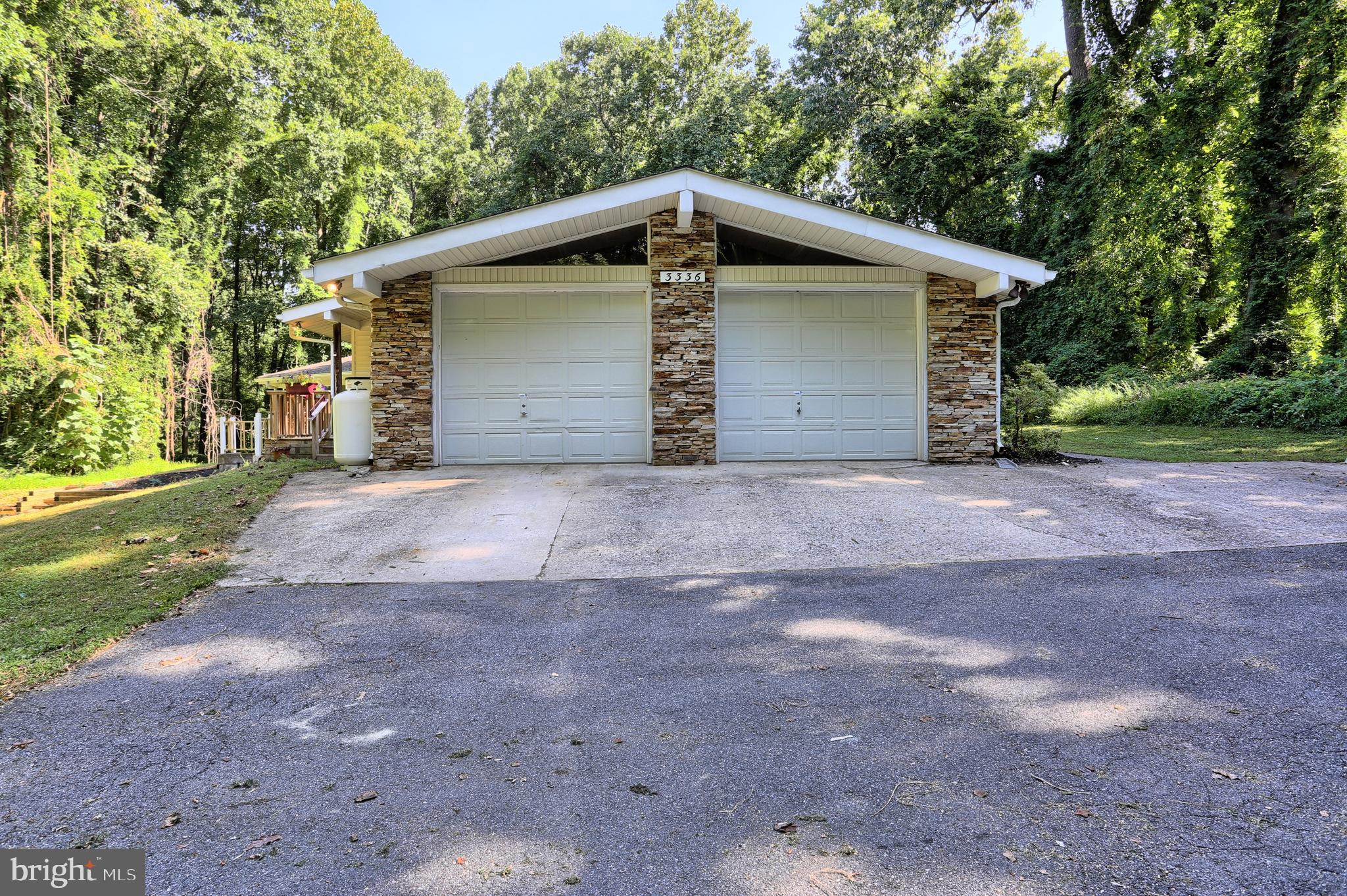 3336 Offutt Road Randallstown, MD 21133 - Photo 39 of 45 a view of a house with a yard and garage