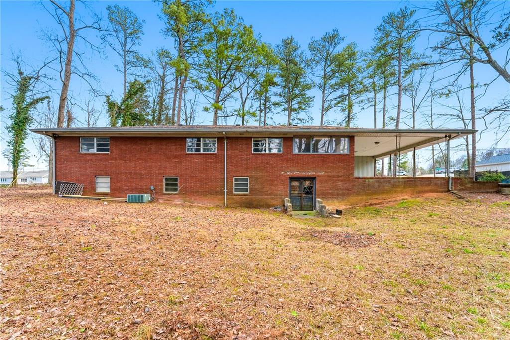 948 Powder Springs Street Marietta, GA 30064 - Photo 13 of 24 a backyard of a house with lots of green space