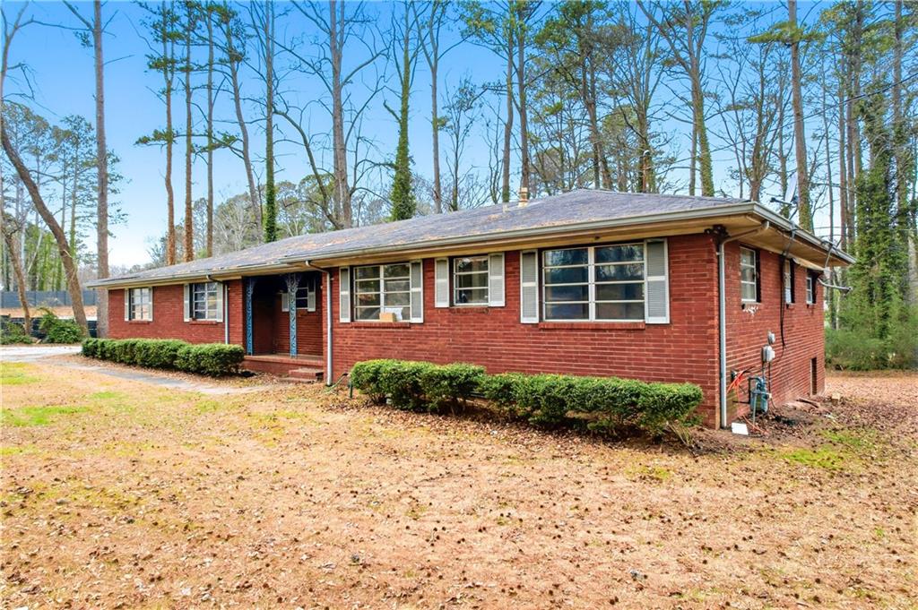 948 Powder Springs Street Marietta, GA 30064 - Photo 5 of 24 a front view of a house with a yard