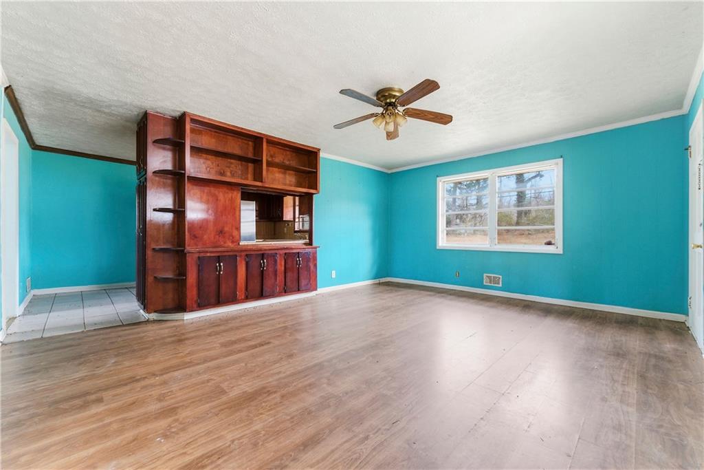 948 Powder Springs Street Marietta, GA 30064 - Photo 9 of 24 a view of empty room with wooden floor and fan