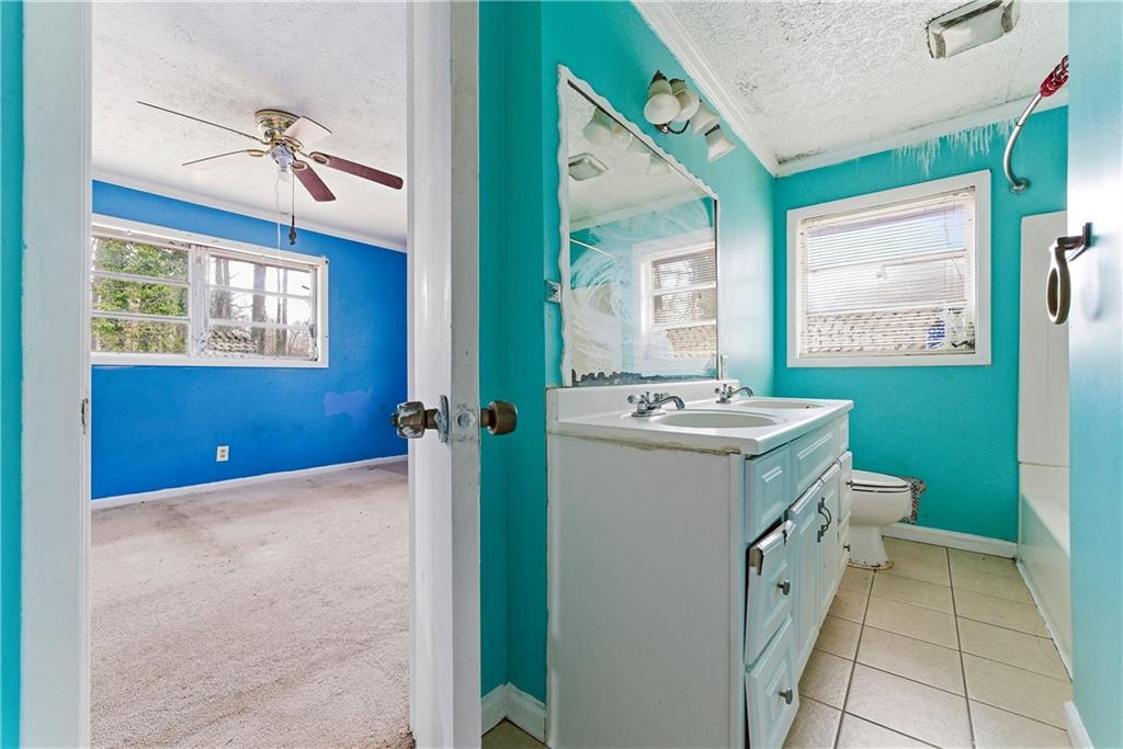 948 Powder Springs Street Marietta, GA 30064 - Photo 10 of 24 a bathroom with a sink mirror and toilet