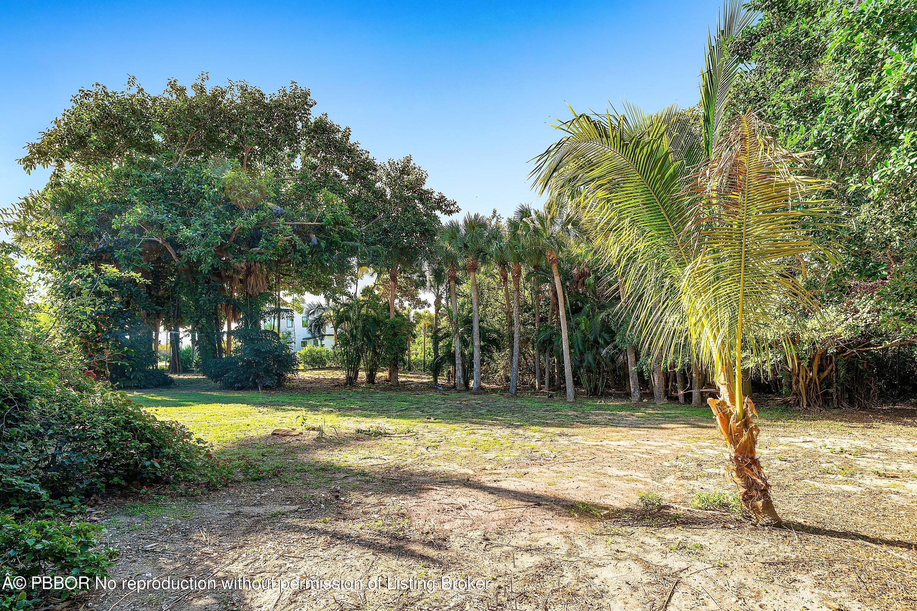 4 Whitney Way Ocean Ridge, FL 33435 - Photo 11 of 13 a view of a house with a yard and tree s