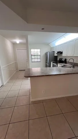 a kitchen with stainless steel appliances a sink a stove a microwave and cabinets