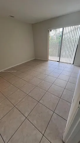 a view of an empty room and a window