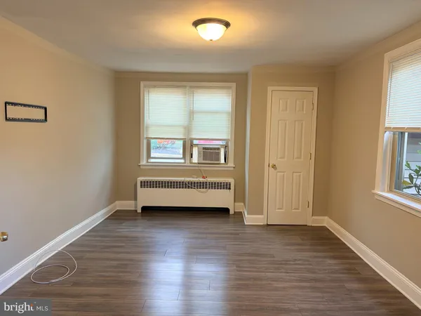 a view of a room with wooden floor and window