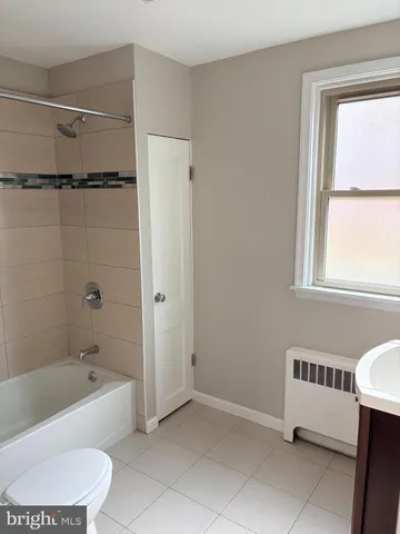 a bathroom with a bathtub a toilet and a bathtub