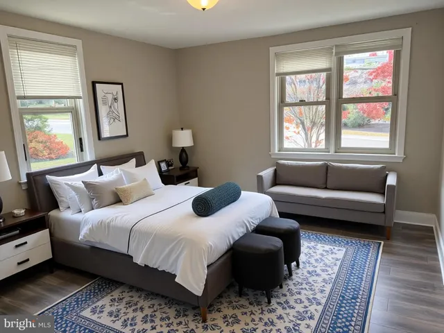 a bedroom with a bed couch and a window