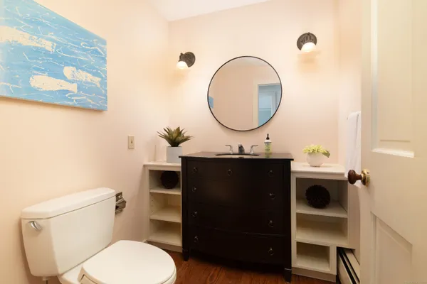 a bathroom with a toilet a sink and a mirror