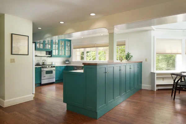 a kitchen with granite countertop a stove a sink and a refrigerator