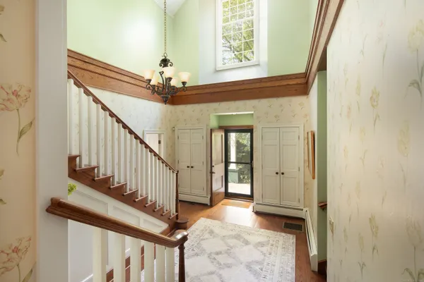 a view of entryway and hall with wooden floor