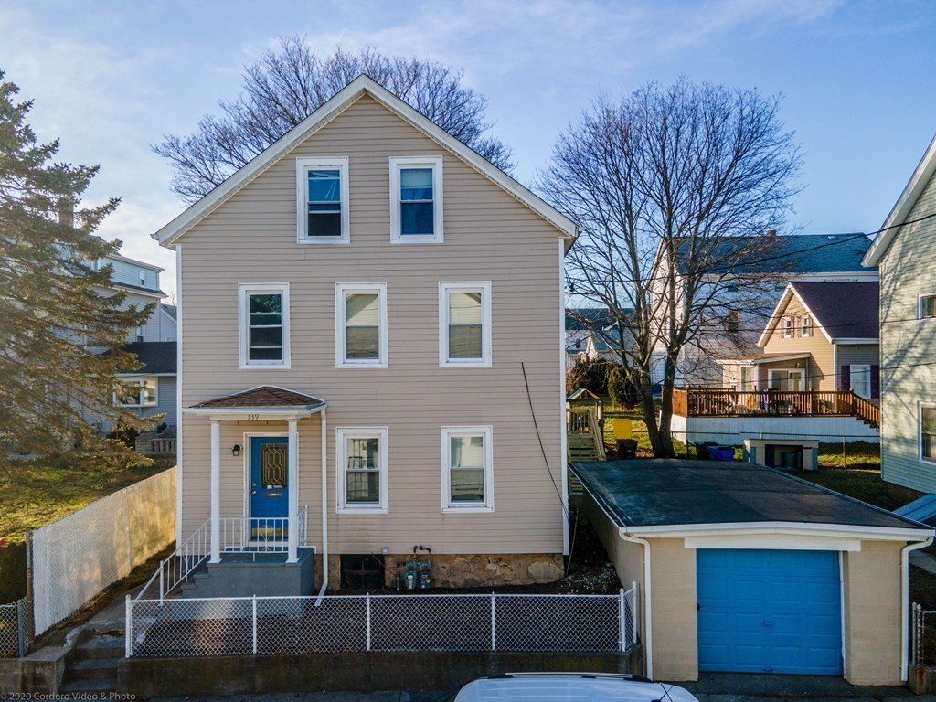 139 Jackson Street Fall River, MA 02721 - Photo 3 of 22 a front view of a house with a yard