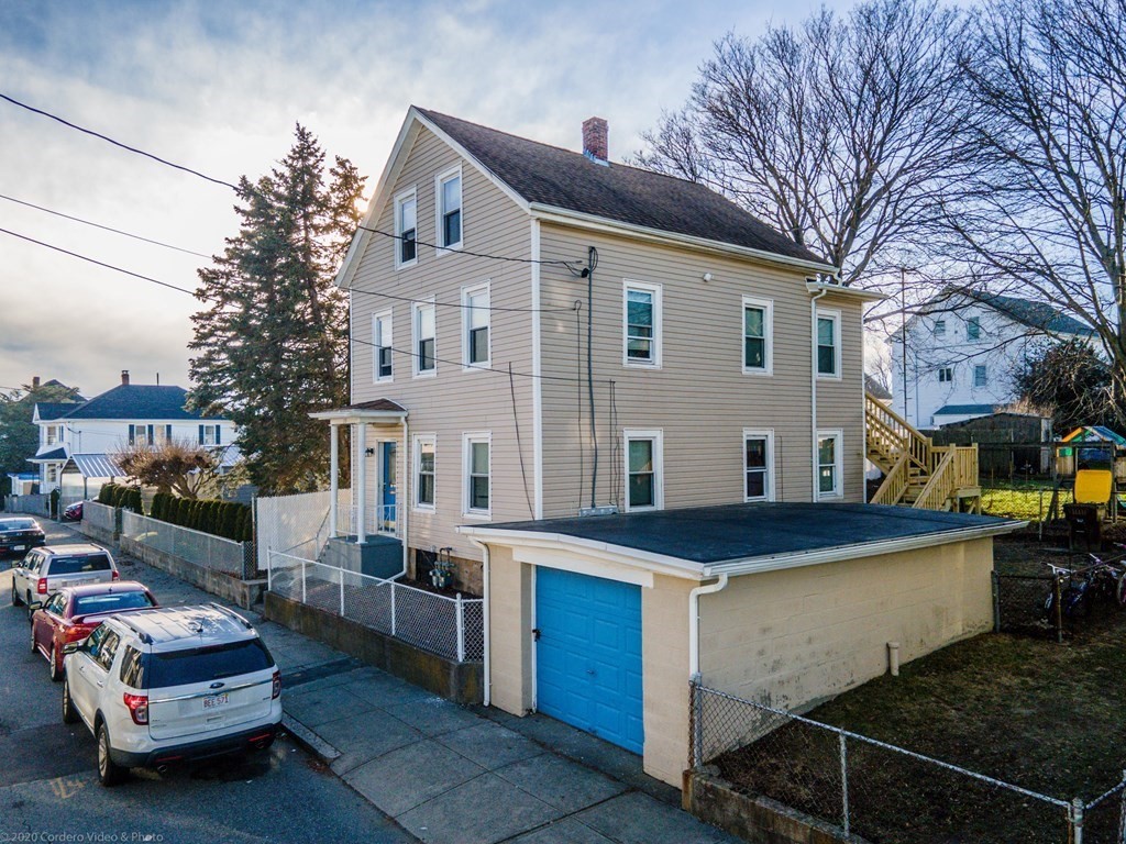 139 Jackson Street Fall River, MA 02721 - Photo 5 of 22 a view of a white house with a yard and roof