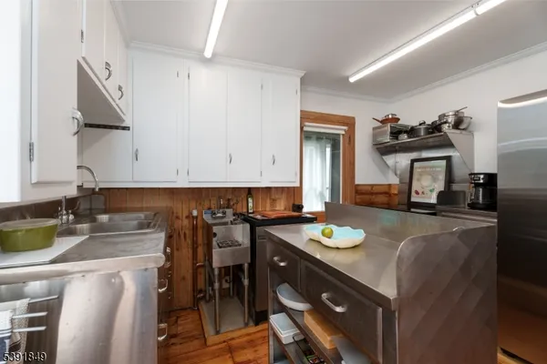 a kitchen with a sink a stove and chairs