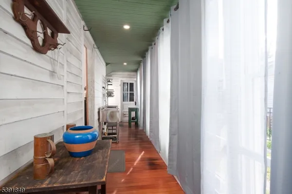 a dining room with furniture and a potted plant