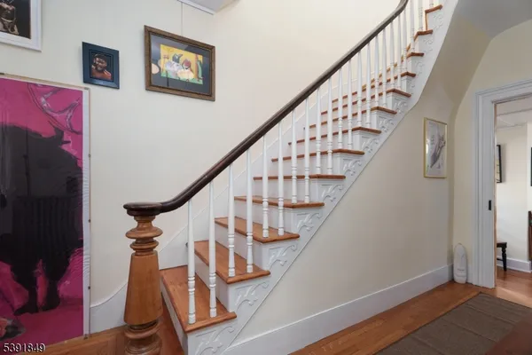 a view of entryway with wooden floor and stairs