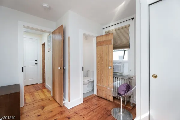 a room that has a door and a chair in it