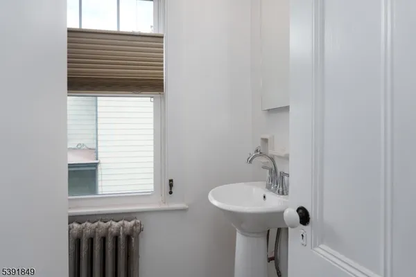 a bathroom with a sink a window and a mirror