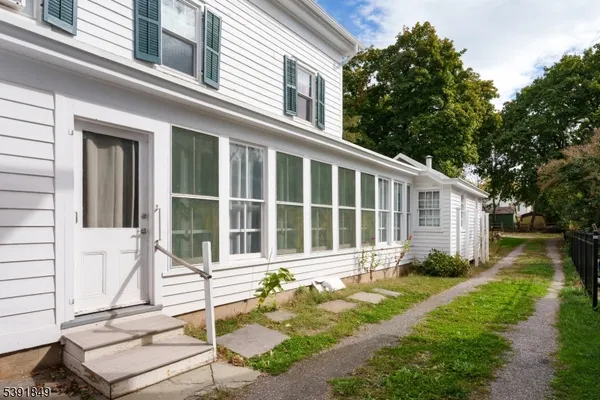 a front view of a house with a yard outdoor seating