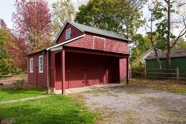 a view of a house with a yard and tree