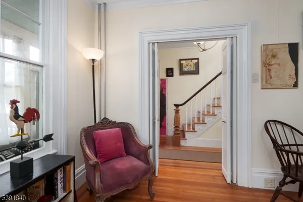 a hallway with chairs and wooden floor