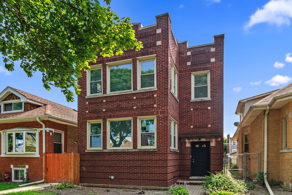 4313 West Parker Avenue Chicago, IL 60639 - Photo 1 of 17 a view of a brick building with many windows