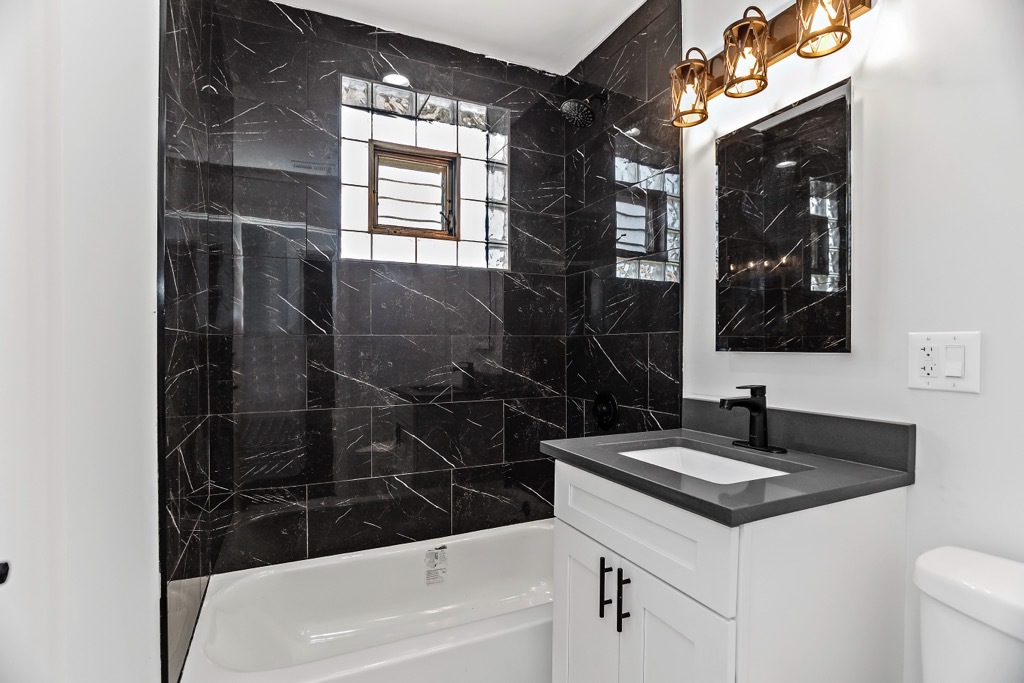 4313 West Parker Avenue Chicago, IL 60639 - Photo 14 of 17 a bathroom with a sink a vanity and a mirror