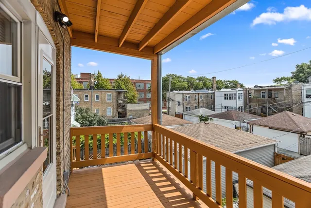 a view of a balcony with wooden floor
