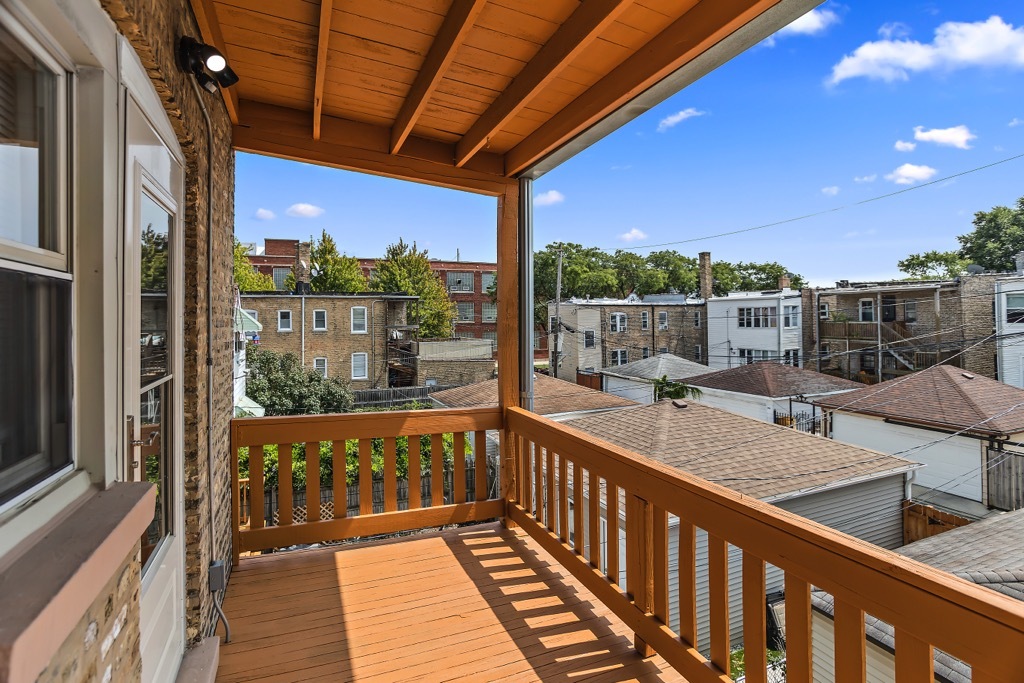 4313 West Parker Avenue Chicago, IL 60639 - Photo 15 of 17 a view of a balcony with wooden floor