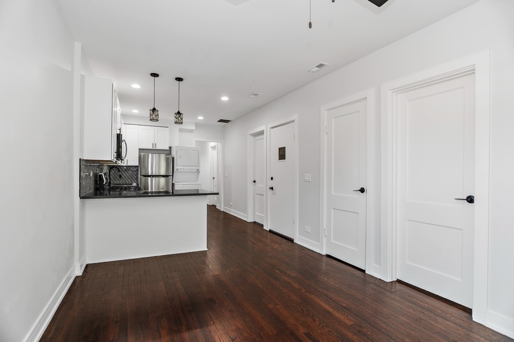 4313 West Parker Avenue Chicago, IL 60639 - Photo 3 of 17 a view of a kitchen with wooden floor and cabinets